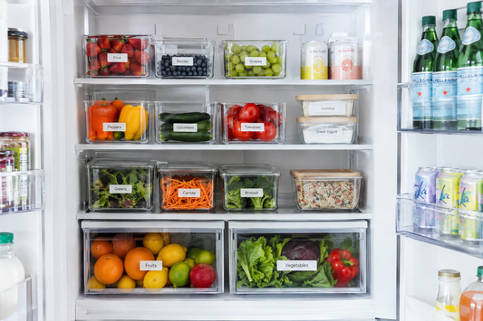 Organized refrigerator interior with clear storage bins and fresh produce